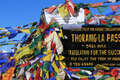 Prayer Flags And Signboard On The Thorang La Mountain Pass